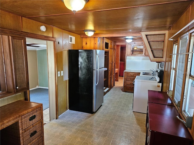 1424 Lake Shore Dr, Casselberry, FL 32707 - kitchen with freestanding refrigerator, range, wooden walls, and visible vents