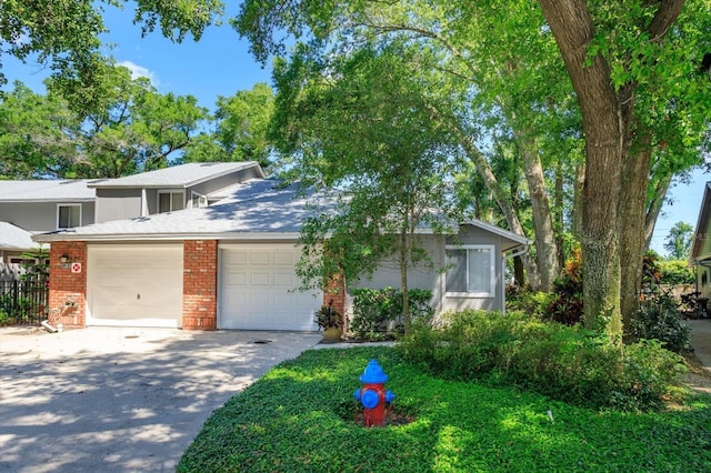 617 Red Oak Cir Unit 121, Altamonte Springs, FL 32701 - view of front of home featuring concrete driveway, brick siding, and a garage