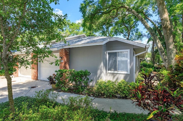 617 Red Oak Cir Unit 121, Altamonte Springs, FL 32701 - view of side of home with an attached garage, driveway, and brick siding