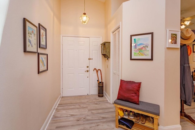617 Red Oak Cir Unit 121, Altamonte Springs, FL 32701 - foyer entrance with light wood finished floors, baseboards, and a towering ceiling