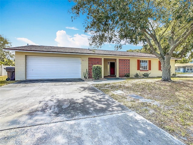 single story home with concrete driveway and a garage