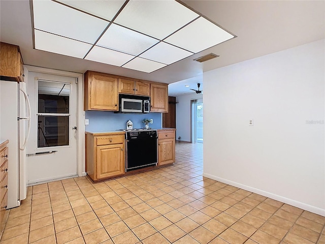 kitchen with light countertops, freestanding refrigerator, stainless steel microwave, baseboards, and dishwasher