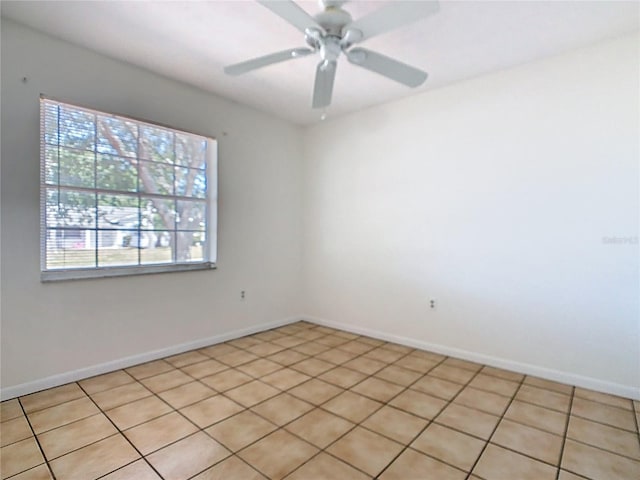 spare room featuring baseboards and ceiling fan