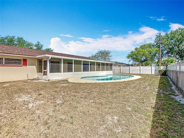 view of swimming pool with a fenced backyard, a sunroom, a fenced in pool, and a yard