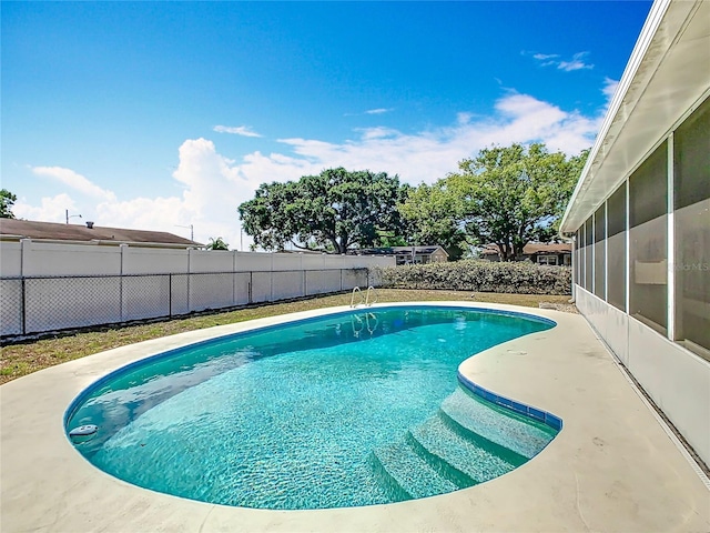 view of pool with a sunroom, a fenced in pool, and a fenced backyard