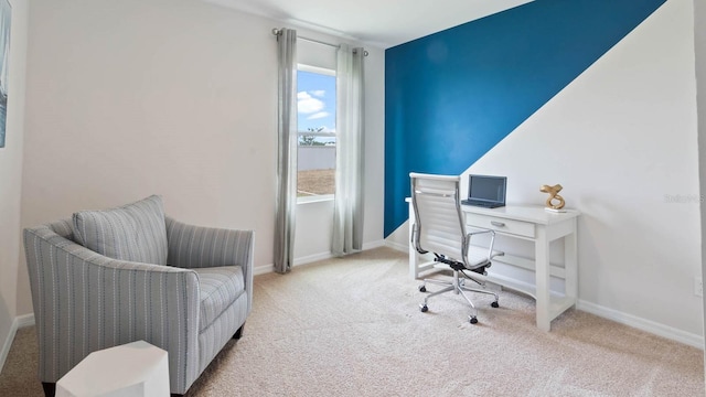 carpeted home office featuring baseboards