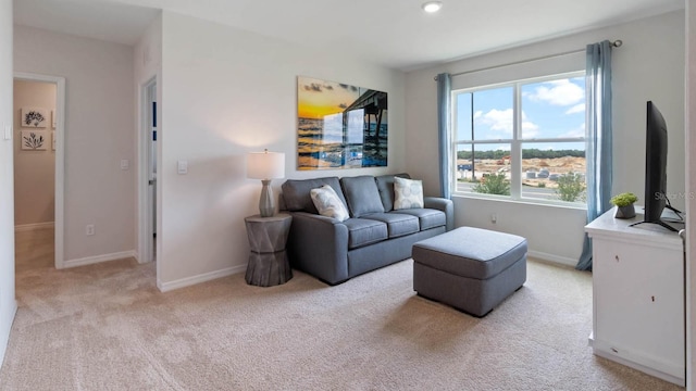 living area featuring baseboards, light carpet, and recessed lighting