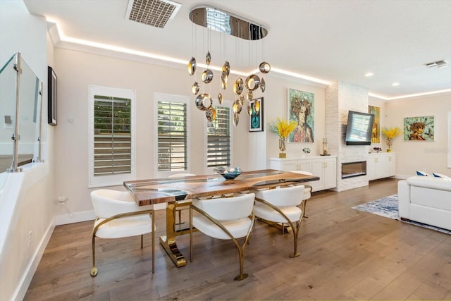 1831 Mizell Ave, Winter Park, FL 32789 - dining room featuring wood finished floors, baseboards, recessed lighting, and a fireplace