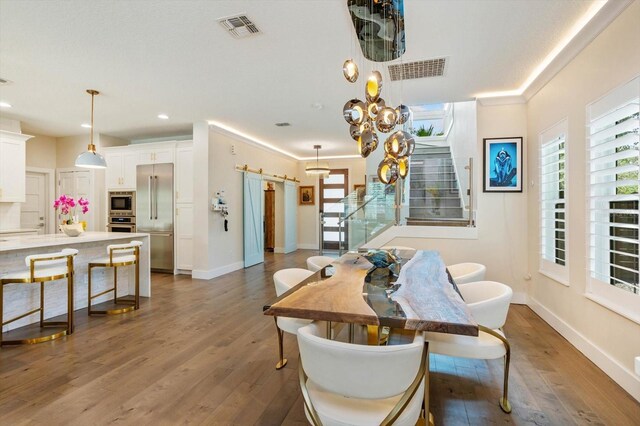 1831 Mizell Ave, Winter Park, FL 32789 - dining area featuring stairs, dark wood finished floors, recessed lighting, a barn door, and baseboards