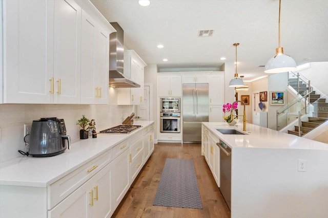 1831 Mizell Ave, Winter Park, FL 32789 - kitchen featuring a sink, appliances with stainless steel finishes, wall chimney range hood, decorative backsplash, and recessed lighting