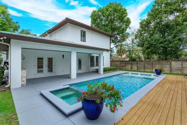 1831 Mizell Ave, Winter Park, FL 32789 - back of property with french doors, a fenced backyard, a patio, stucco siding, and a pool with connected hot tub