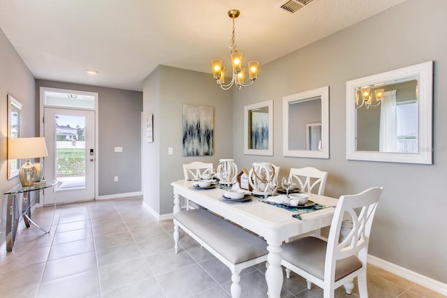 dining room with an inviting chandelier, baseboards, light tile patterned floors, and visible vents
