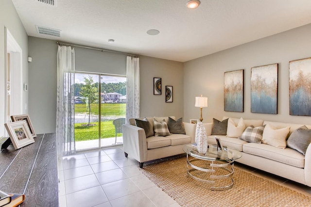 living area featuring tile patterned flooring and visible vents