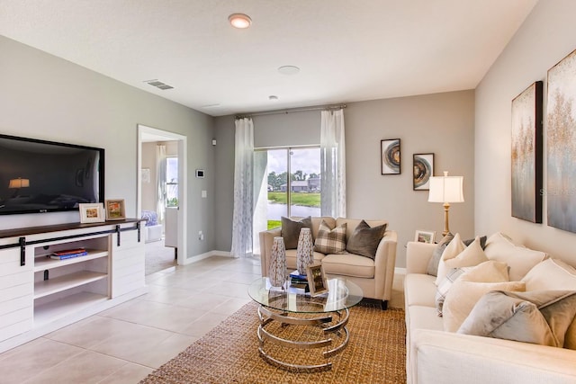 living area featuring baseboards, a water view, visible vents, and light tile patterned flooring