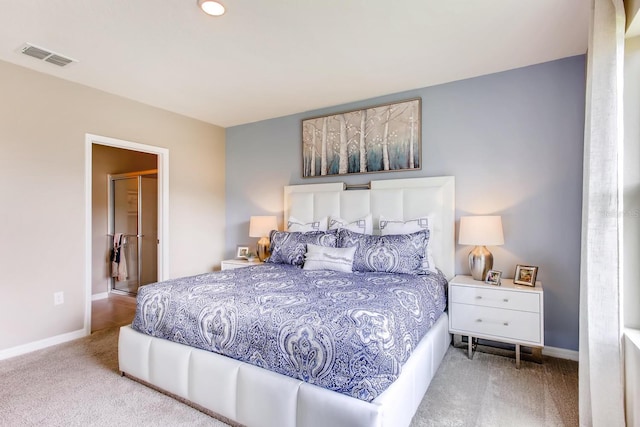 carpeted bedroom with baseboards and visible vents