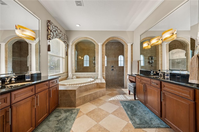 bathroom with walk in shower, a sink, visible vents, and ornate columns