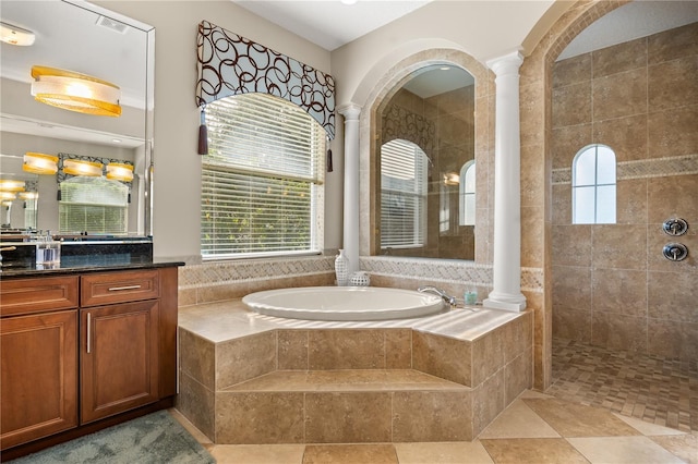 bathroom with a garden tub, vanity, ornate columns, and a walk in shower