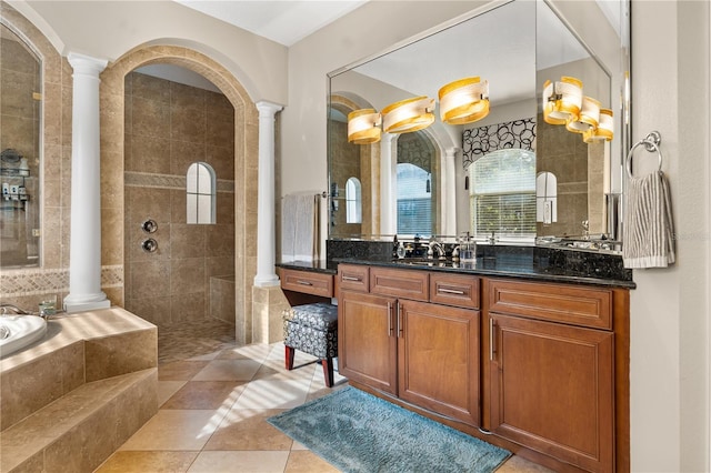 bathroom featuring walk in shower, vanity, ornate columns, tile patterned floors, and a relaxing tiled tub