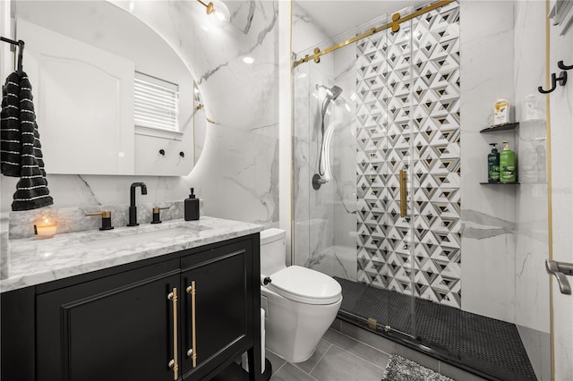 full bathroom featuring a shower stall, vanity, and toilet