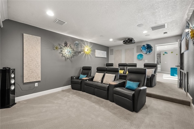 carpeted home theater featuring baseboards, recessed lighting, visible vents, and a textured ceiling