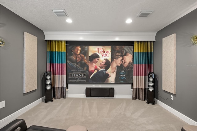 carpeted cinema room featuring a textured ceiling, baseboards, and visible vents