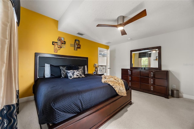 bedroom with ceiling fan, light carpet, baseboards, and visible vents