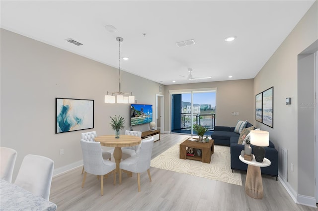 7565 Laureate Blvd Unit 3408, Orlando, FL 32827 - dining space featuring light wood-style floors, baseboards, recessed lighting, a chandelier, and ceiling fan