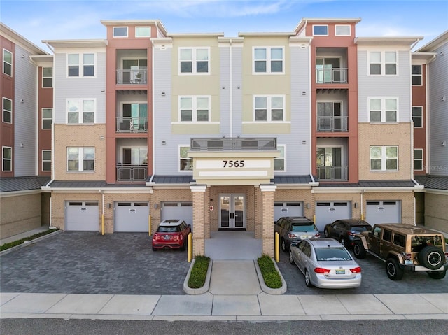 7565 Laureate Blvd Unit 3408, Orlando, FL 32827 - view of building exterior with driveway and a garage