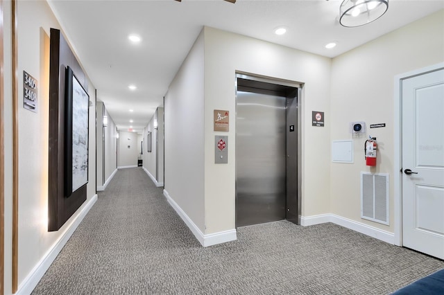 7565 Laureate Blvd Unit 3408, Orlando, FL 32827 - hallway featuring elevator, carpet flooring, baseboards, and recessed lighting