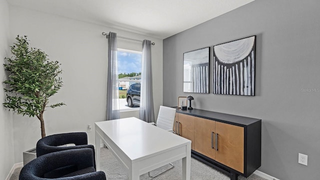 office area featuring baseboards and carpet flooring