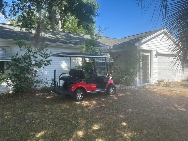 1707 E Schwartz Blvd, Lady Lake, FL 32159 - view of home's exterior featuring a shingled roof and a garage