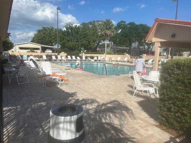 1707 E Schwartz Blvd, Lady Lake, FL 32159 - community pool with a patio area and fence