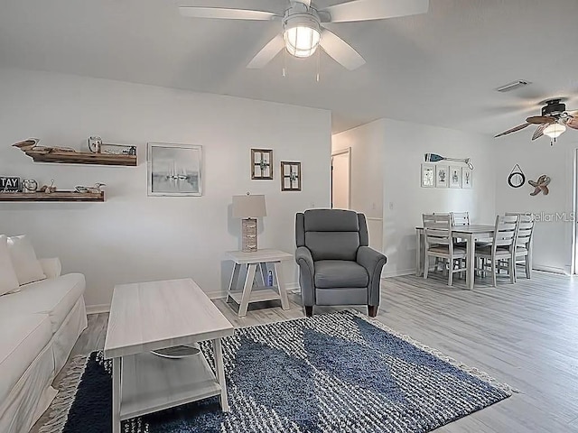 1707 E Schwartz Blvd, Lady Lake, FL 32159 - living room with a ceiling fan, baseboards, and wood finished floors