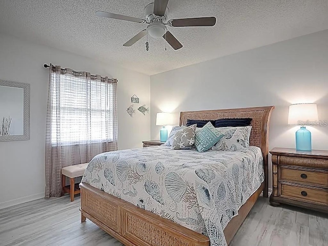 1707 E Schwartz Blvd, Lady Lake, FL 32159 - bedroom featuring light wood-type flooring, a textured ceiling, ceiling fan, and baseboards
