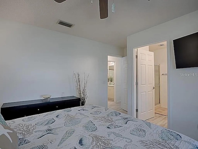 1707 E Schwartz Blvd, Lady Lake, FL 32159 - bedroom with light wood-type flooring, connected bathroom, and a ceiling fan