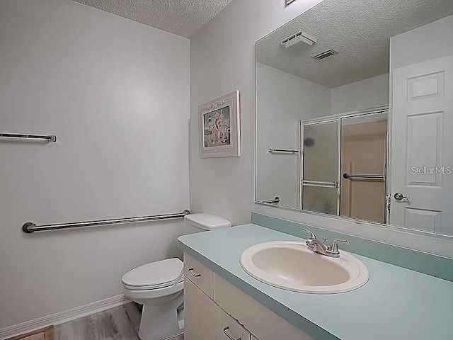 1707 E Schwartz Blvd, Lady Lake, FL 32159 - full bath featuring a textured ceiling, a shower stall, vanity, toilet, and wood finished floors