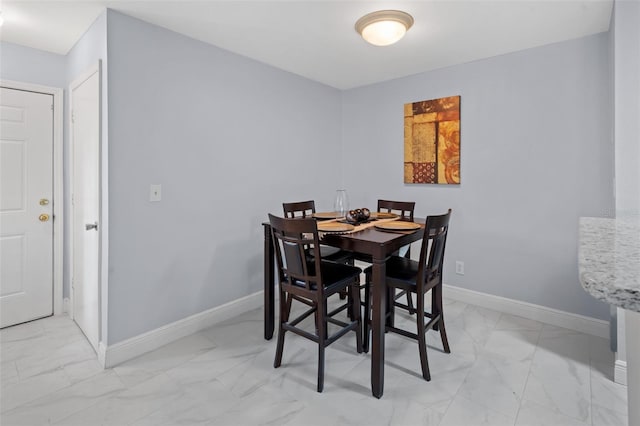 dining room featuring baseboards and marble finish floor