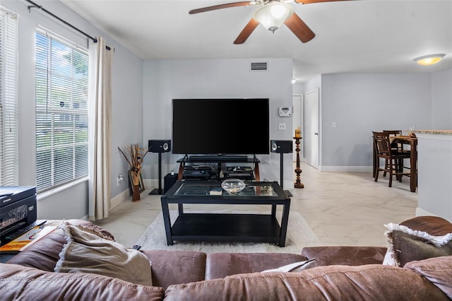 living area featuring baseboards, marble finish floor, ceiling fan, and visible vents
