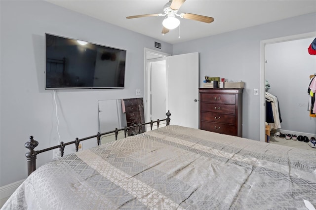 bedroom with ceiling fan, baseboards, and visible vents