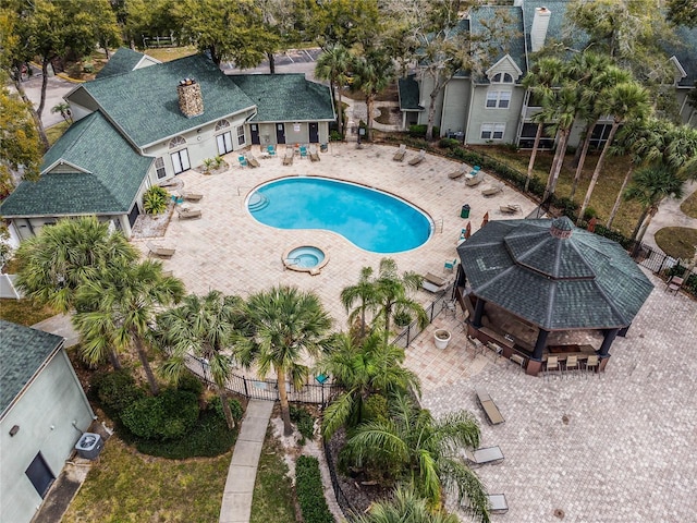 community pool featuring a patio and fence