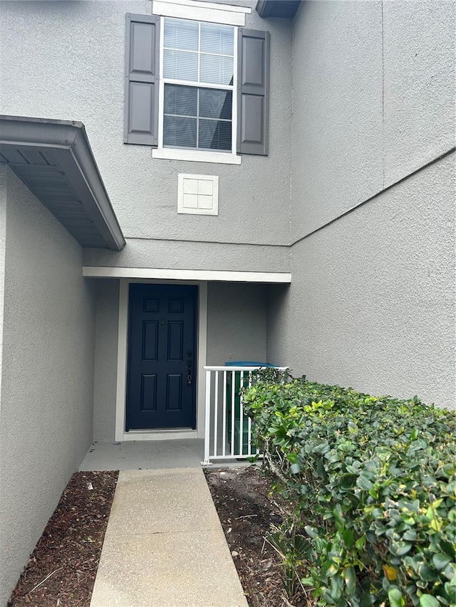 135 Heritage Park St, Winter Springs, FL 32708 - property entrance featuring stucco siding