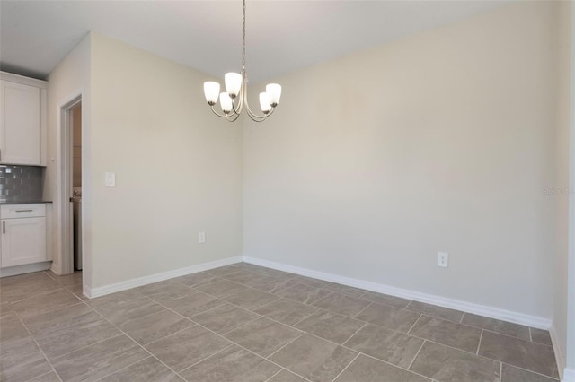 unfurnished dining area with a notable chandelier, baseboards, and light tile patterned floors