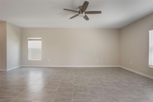 unfurnished room with ceiling fan, baseboards, and light tile patterned floors