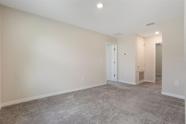 carpeted spare room featuring visible vents, baseboards, and recessed lighting