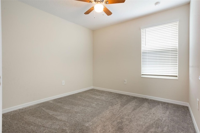 unfurnished room with carpet flooring, baseboards, a ceiling fan, and a wealth of natural light