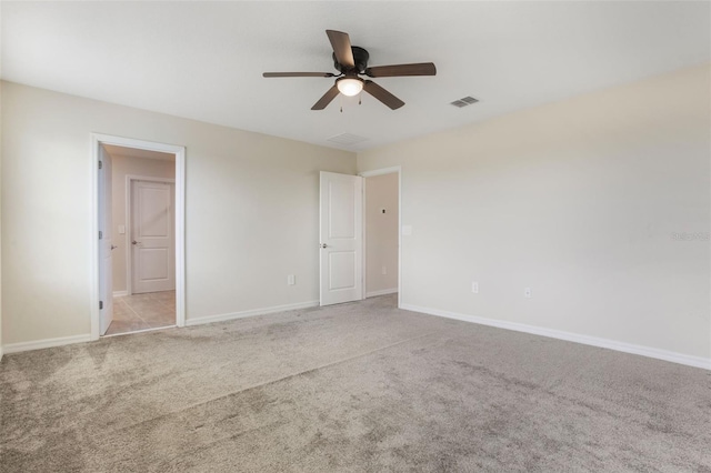 interior space with ceiling fan, carpet floors, baseboards, and visible vents