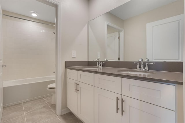 bathroom featuring a sink, double vanity, toilet, and shower / bathtub combination