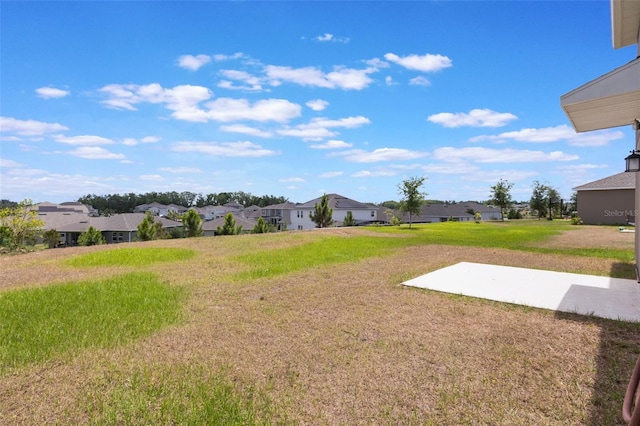 view of yard with a patio area and a residential view