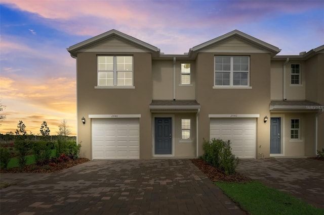 2975 Brie Hammock Bnd, Saint Cloud, FL 34773 - multi unit property with an attached garage, stucco siding, and decorative driveway