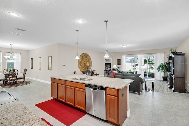 kitchen featuring a sink, brown cabinets, a kitchen island with sink, visible vents, and dishwasher